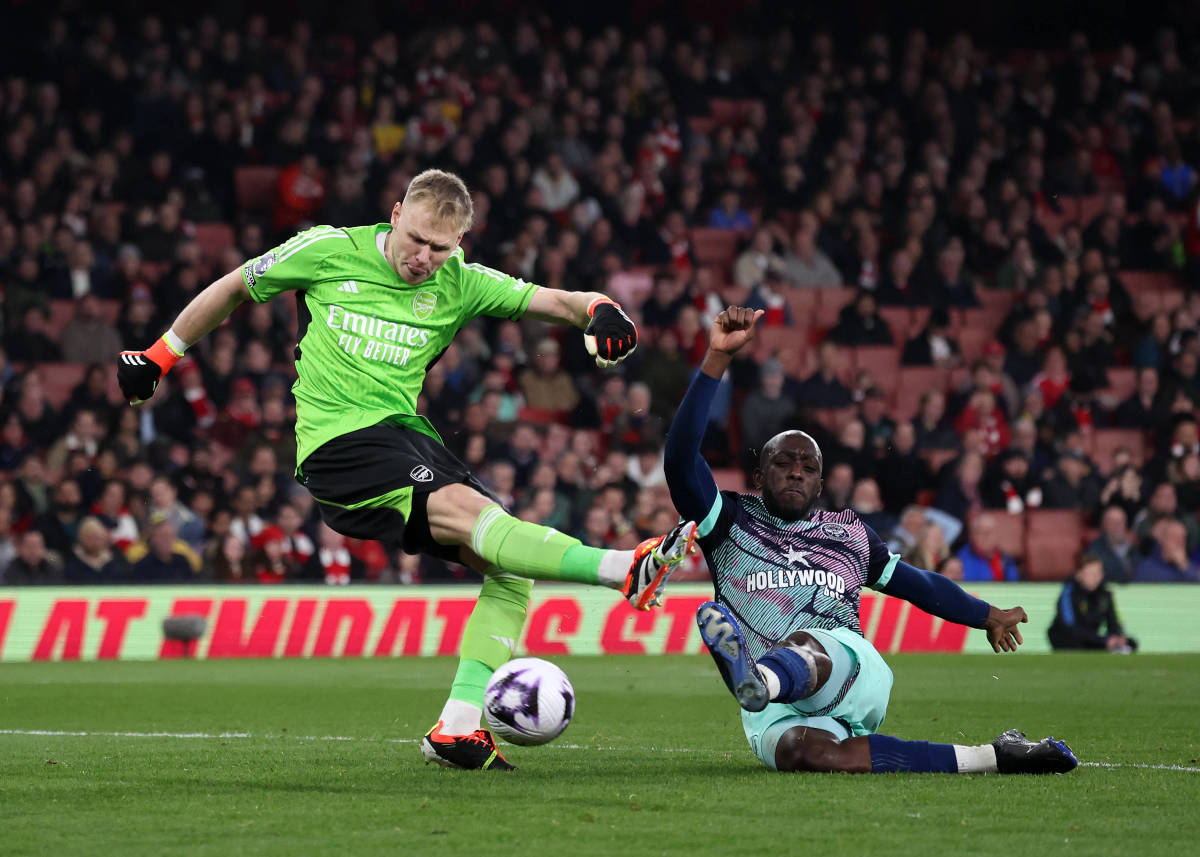 Yoane Wissa pictured (right) scoring for Brentford by tackling Arsenal goalkeeper Aaron Ramsdale during a Premier League game in March 2024